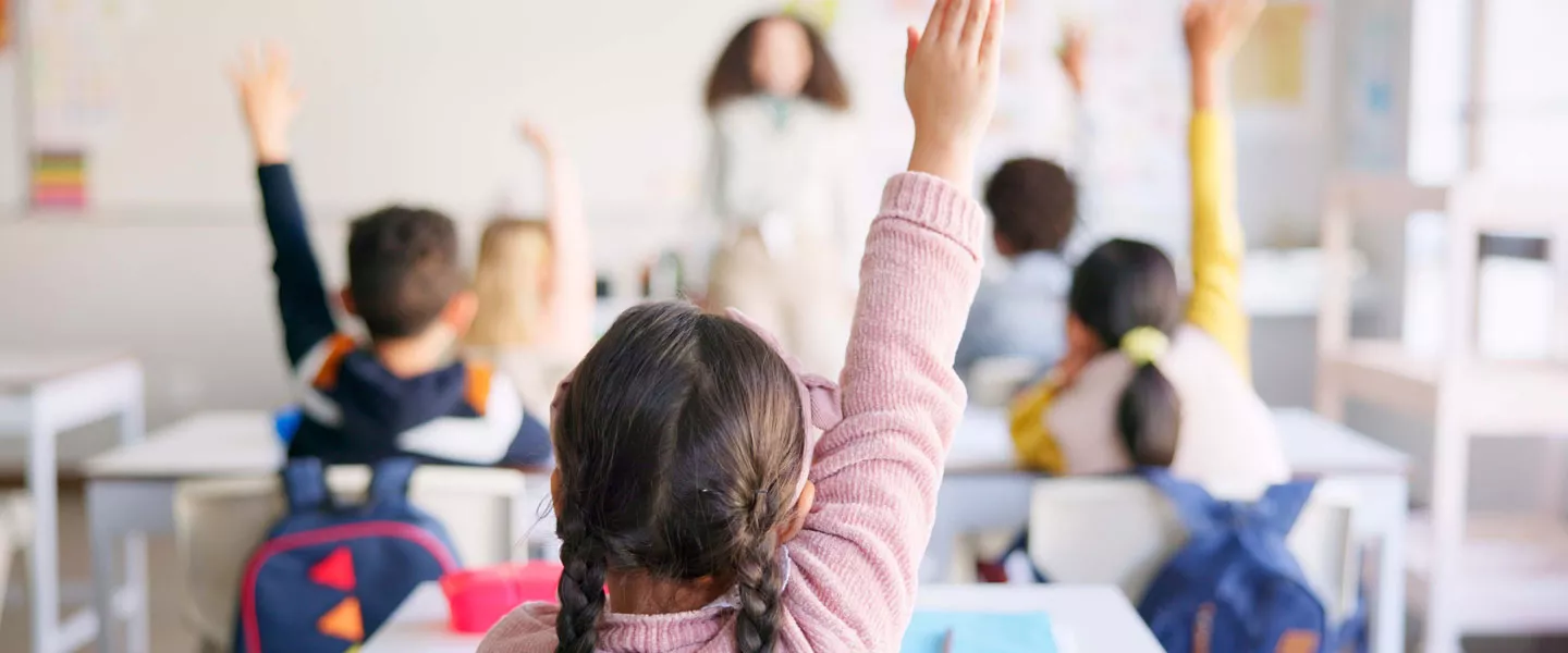 student with raised hand